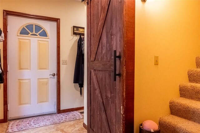 205 Hickman Dr, Bowling Green, MO 63334 - entryway with stairway, a barn door, and baseboards