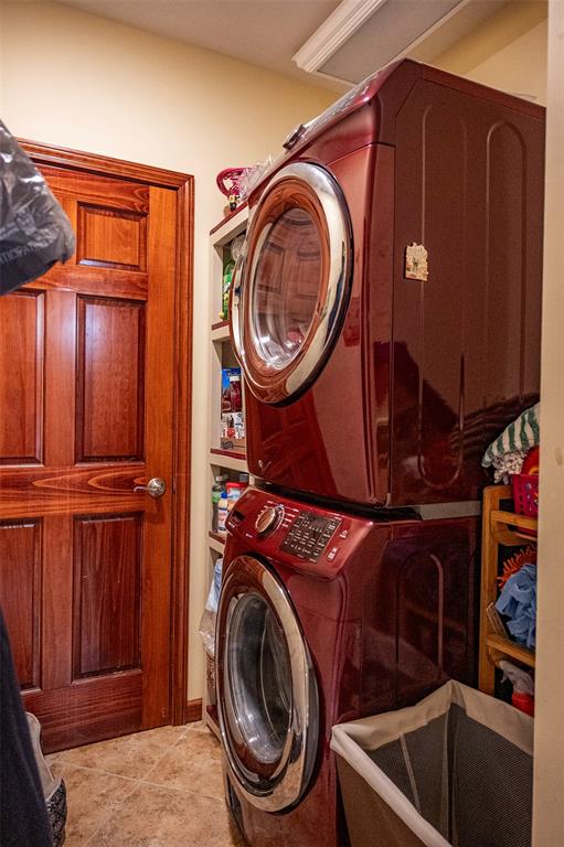 205 Hickman Dr, Bowling Green, MO 63334 - washroom with stacked washer / dryer