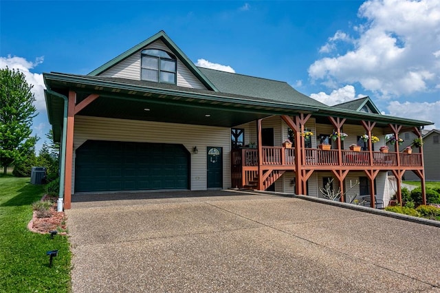 205 Hickman Dr, Bowling Green, MO 63334 - view of front of home featuring asphalt driveway, cooling unit, and a porch