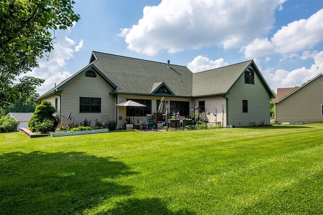 205 Hickman Dr, Bowling Green, MO 63334 - back of property featuring a patio, a yard, and roof with shingles