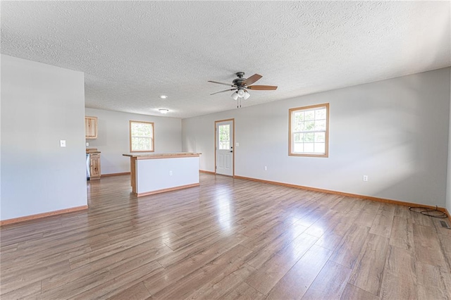 26805 Stephanie Ln, Laquey, MO 65534 - spare room featuring ceiling fan, wood finished floors, a textured ceiling, and baseboards