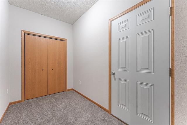 26805 Stephanie Ln, Laquey, MO 65534 - unfurnished bedroom featuring carpet, baseboards, a closet, and a textured ceiling