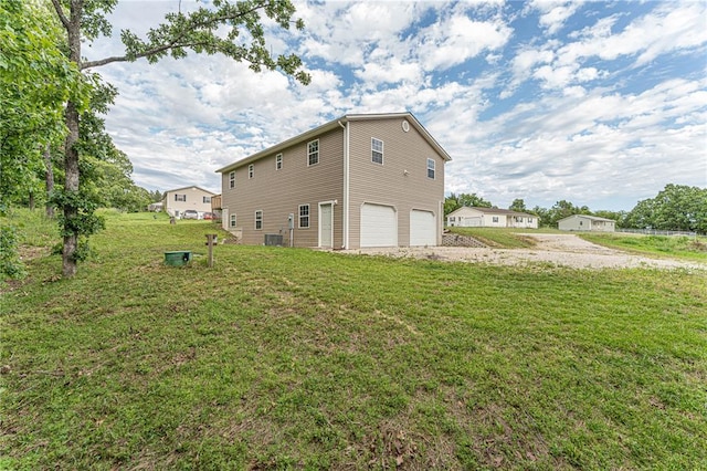 26805 Stephanie Ln, Laquey, MO 65534 - view of side of property featuring a garage, gravel driveway, central AC, and a yard