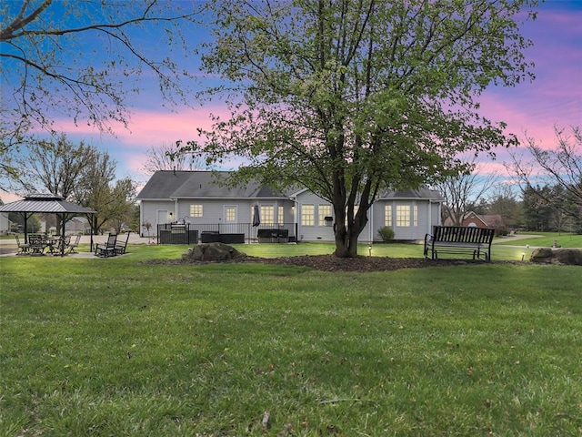 3 Jura Ct, Ofallon, MO 63368 - back of house at dusk with a gazebo and a yard