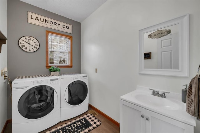 3 Jura Ct, Ofallon, MO 63368 - washroom featuring separate washer and dryer, wood finished floors, baseboards, and cabinet space