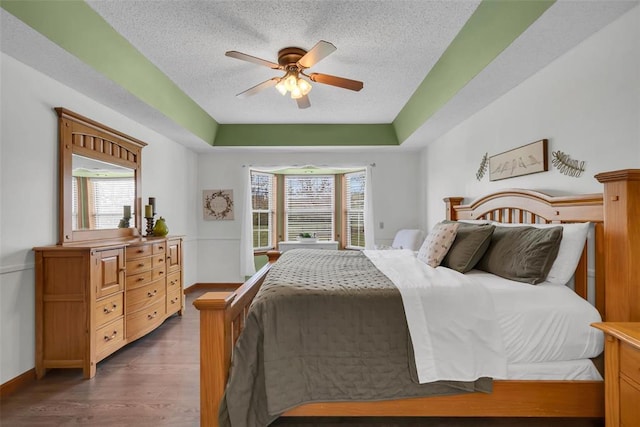 3 Jura Ct, Ofallon, MO 63368 - bedroom featuring a textured ceiling, dark wood-style flooring, baseboards, and ceiling fan