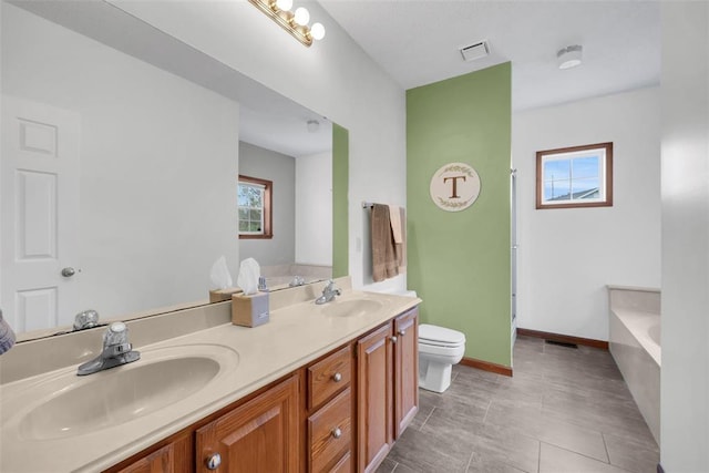 3 Jura Ct, Ofallon, MO 63368 - bathroom with toilet, plenty of natural light, double vanity, and a garden tub