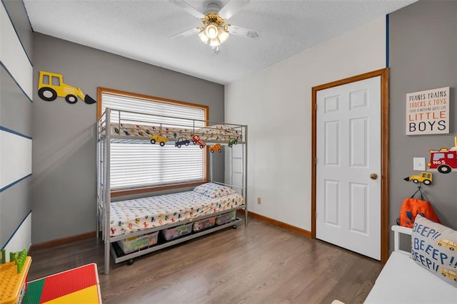 3 Jura Ct, Ofallon, MO 63368 - bedroom with wood finished floors, a textured ceiling, baseboards, and a ceiling fan