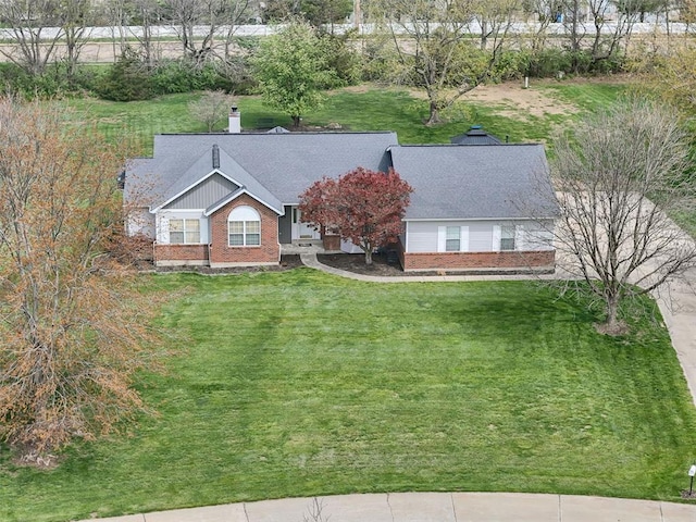 3 Jura Ct, Ofallon, MO 63368 - view of front facade with brick siding, a front yard, and a chimney