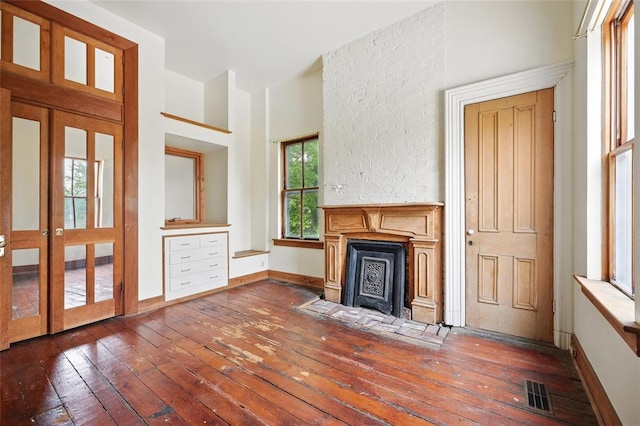 1225 Mackay Pl, Saint Louis, MO 63104 - unfurnished living room featuring dark wood-type flooring, baseboards, and a fireplace with flush hearth