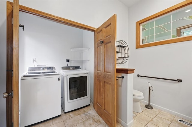 1225 Mackay Pl, Saint Louis, MO 63104 - laundry area featuring washer and dryer, light tile patterned flooring, and baseboards