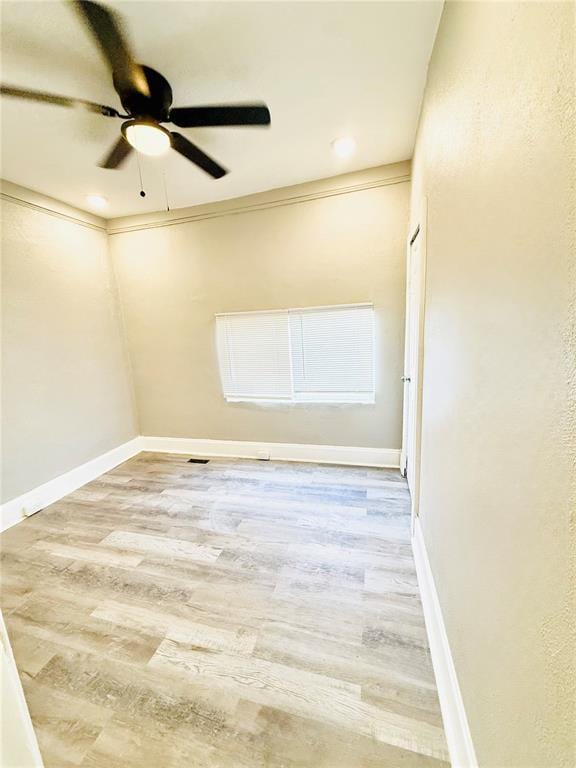 spare room with wood finished floors, a ceiling fan, baseboards, and recessed lighting
