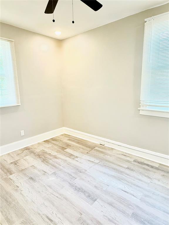 spare room featuring ceiling fan, wood finished floors, baseboards, and recessed lighting