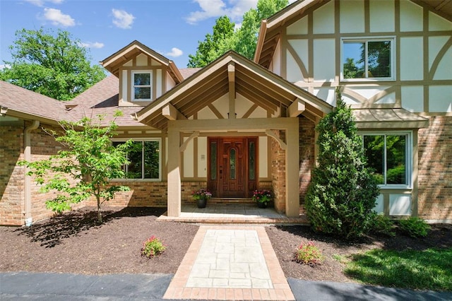 1807 Brookcreek Ln, Kirkwood, MO 63122 - doorway to property with brick siding, roof with shingles, and stucco siding