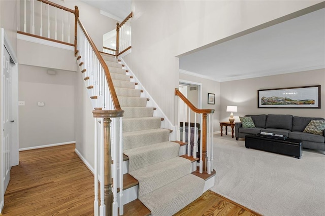 1807 Brookcreek Ln, Kirkwood, MO 63122 - stairway featuring crown molding, wood finished floors, baseboards, and a high ceiling