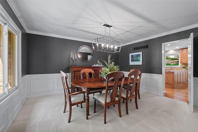 1807 Brookcreek Ln, Kirkwood, MO 63122 - dining room with light colored carpet, ornamental molding, wainscoting, a decorative wall, and a chandelier