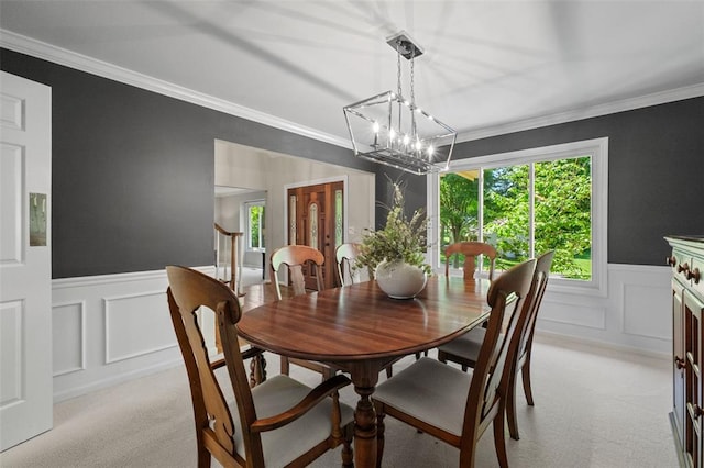1807 Brookcreek Ln, Kirkwood, MO 63122 - dining area with a decorative wall, light carpet, a chandelier, a wainscoted wall, and crown molding