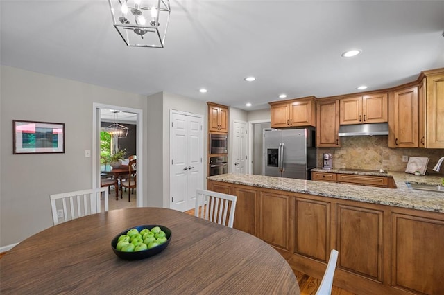 1807 Brookcreek Ln, Kirkwood, MO 63122 - kitchen with appliances with stainless steel finishes, under cabinet range hood, a chandelier, a sink, and backsplash