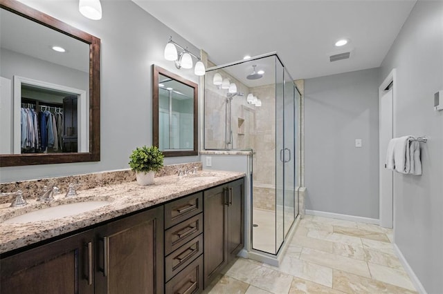 1807 Brookcreek Ln, Kirkwood, MO 63122 - bathroom featuring a shower stall, double vanity, baseboards, recessed lighting, and a spacious closet