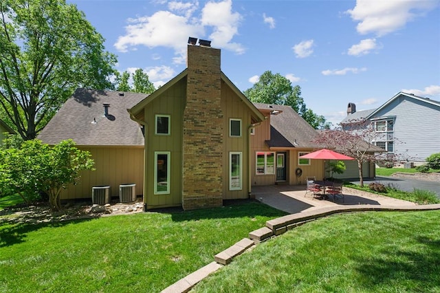 1807 Brookcreek Ln, Kirkwood, MO 63122 - back of house with a chimney, a patio area, a yard, and roof with shingles