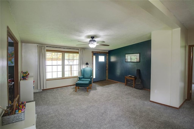 27467 Spruce Rd, Greenfield, IL 62044 - sitting room with carpet, a textured ceiling, baseboards, and a ceiling fan
