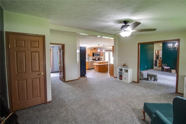 27467 Spruce Rd, Greenfield, IL 62044 - living room with light colored carpet, a ceiling fan, a textured ceiling, and baseboards