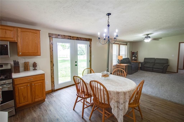 27467 Spruce Rd, Greenfield, IL 62044 - dining room featuring french doors, a textured ceiling, a chandelier, wood finished floors, and baseboards