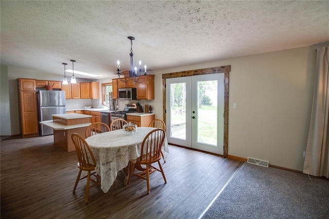 27467 Spruce Rd, Greenfield, IL 62044 - dining area featuring a textured ceiling, baseboards, wood finished floors, a chandelier, and french doors