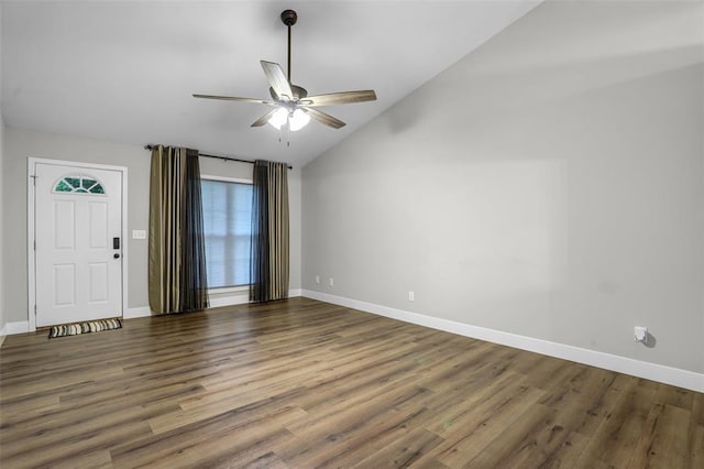 unfurnished room featuring a ceiling fan, lofted ceiling, baseboards, and wood finished floors
