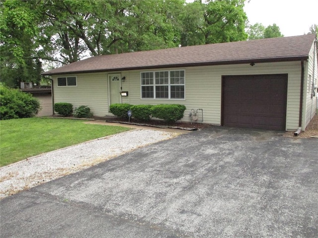 ranch-style house with a garage, driveway, and a front lawn