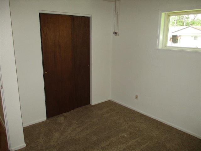 unfurnished bedroom featuring carpet flooring and baseboards