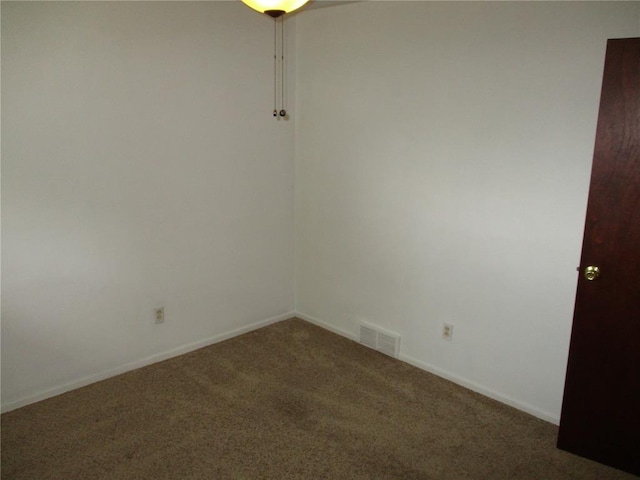 unfurnished room with carpet floors and baseboards