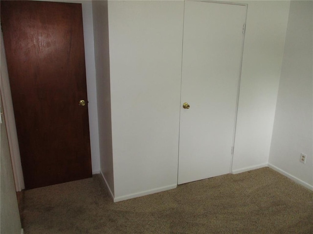 unfurnished bedroom with carpet and baseboards