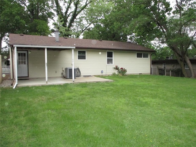 back of property featuring a patio area, cooling unit, and a chimney