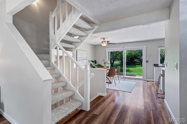 193 Harbor View Dr, Lake St Louis, MO 63367 - stairway with wood finished floors, a textured ceiling, and a ceiling fan