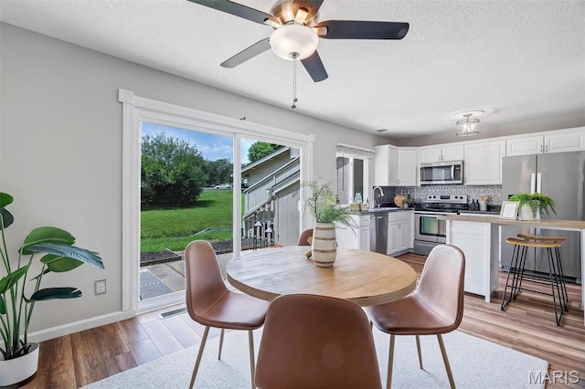 193 Harbor View Dr, Lake St Louis, MO 63367 - dining area with light wood-style floors, ceiling fan, and a textured ceiling