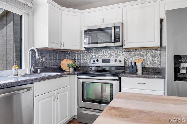 193 Harbor View Dr, Lake St Louis, MO 63367 - kitchen featuring stainless steel appliances, white cabinets, and backsplash