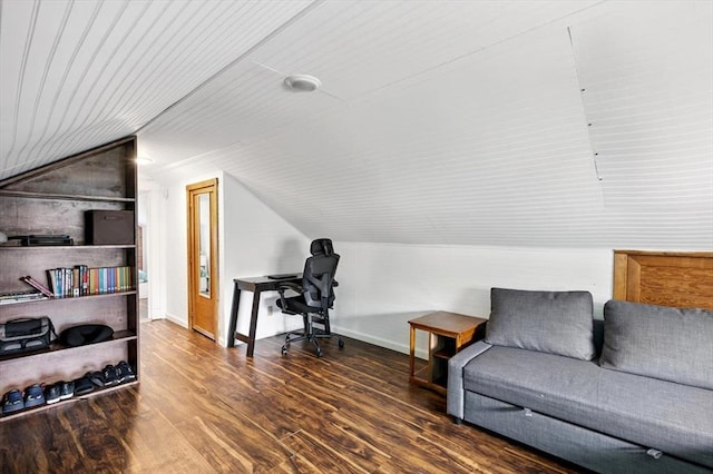 living area featuring lofted ceiling, wood finished floors, and baseboards