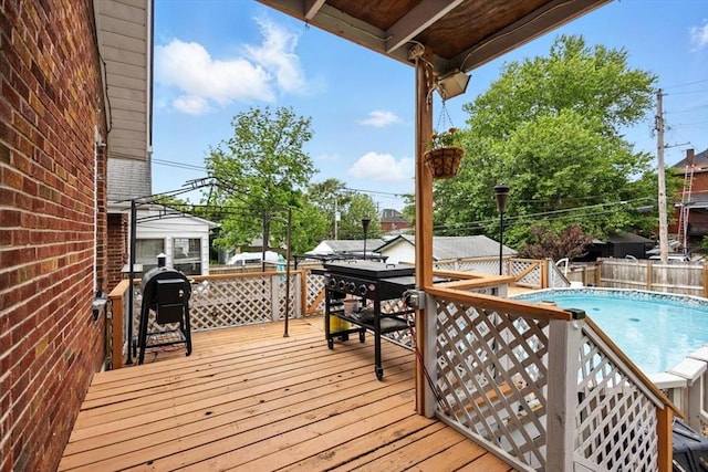 wooden deck featuring fence and grilling area
