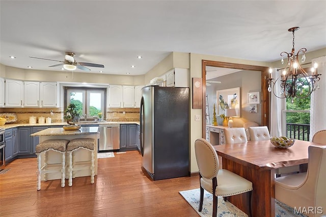 1553 Ridge Rd, Wildwood, MO 63021 - kitchen featuring stainless steel appliances, a ceiling fan, white cabinetry, gray cabinets, and decorative backsplash