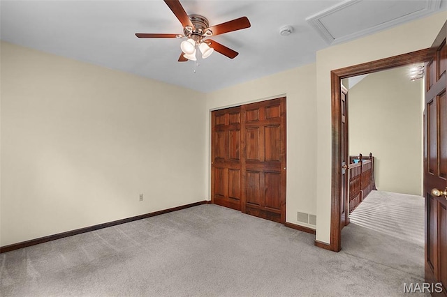1553 Ridge Rd, Wildwood, MO 63021 - unfurnished bedroom featuring light carpet, ceiling fan, attic access, and a closet