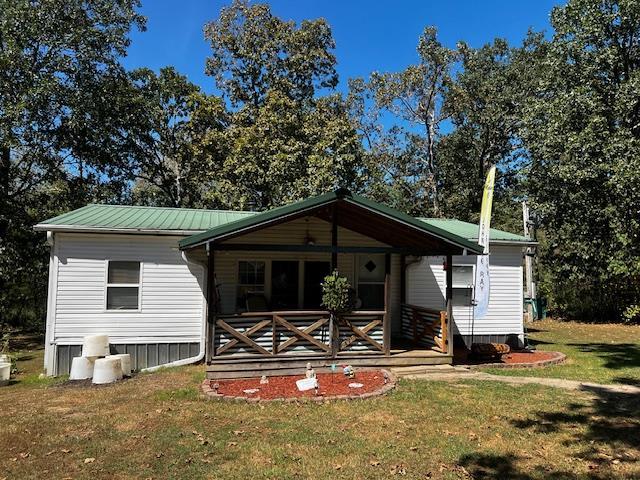 756 Eldon Dr, Bismarck, MO 63624 - view of front of house with a front lawn, covered porch, and metal roof