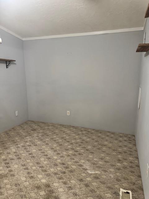 756 Eldon Dr, Bismarck, MO 63624 - carpeted spare room with ornamental molding