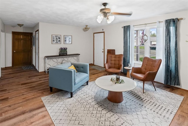 living area featuring wood finished floors and ceiling fan