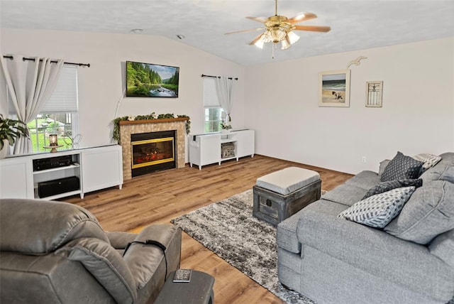 living area with lofted ceiling, a ceiling fan, plenty of natural light, and light wood-type flooring