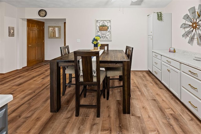 dining area with light wood-style floors