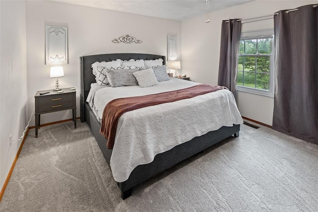 carpeted bedroom featuring baseboards