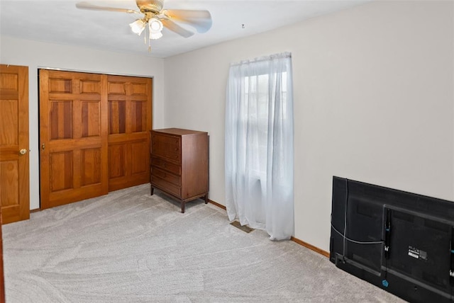 unfurnished bedroom with carpet, baseboards, and ceiling fan