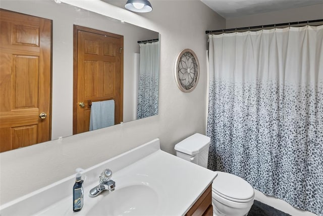 full bathroom featuring toilet, vanity, and a shower with shower curtain