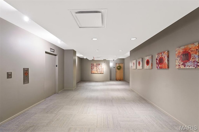 915 Olive St Unit 910, Saint Louis, MO 63101 - corridor featuring light carpet, elevator, and recessed lighting